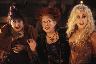 The Sanderson sisters smiling in the Disney movie Hocus Pocus.