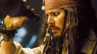 Johnny Depp as Captain Jack Sparrow looking into an empty bottle of rum during the Pirates of the Caribbean movies.