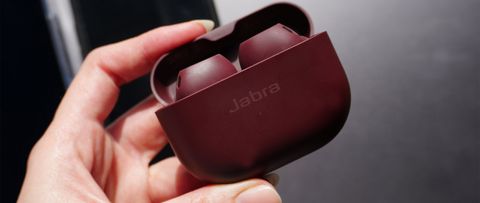 A hand holding the Jabra Elite 10