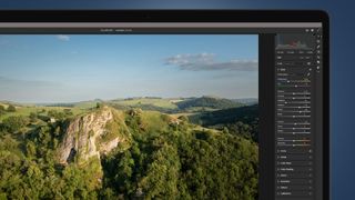 An aerial photo being processed in Lightroom on a laptop