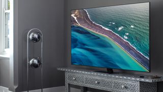 The Samsung Q80T QLED in a living room on a TV stand.