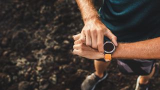 The best running watches: person wearing a running watch close up