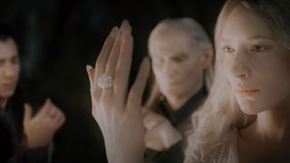 A screenshot from The Fellowship of the Ring movie showing the three elves examining their Rings of Power