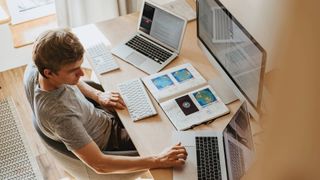 A person working from home using two laptops.