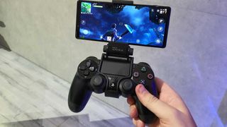 A DualShock 4 controller with a phone attached via phone stand