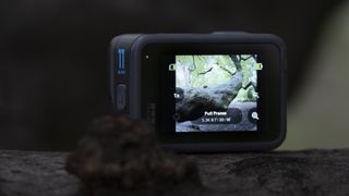 The GoPro Hero 11 Black action camera sitting on a wooden platform