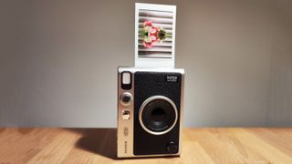 The Fujifilm Instax Mini Evo on a wooden table