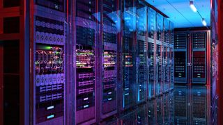 Server room with glowing servers pictured inside a hyperscale data center.