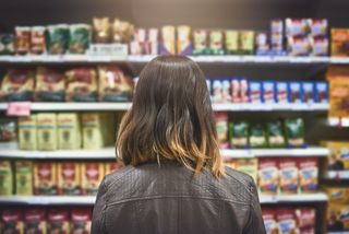 Rearview shot of a young woman shopping at a grocery store