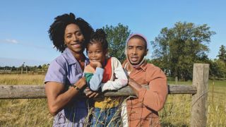 A family photo showing parents and a child outside