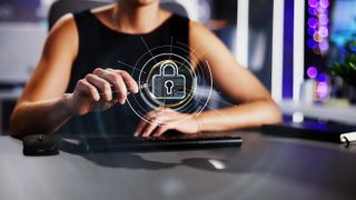 Woman at a desk touching an ethereal VPN-like projection