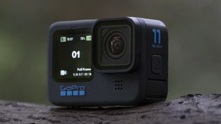 The GoPro Hero 11 Black action camera sitting on a wooden platform