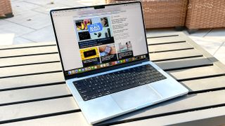 MacBook Pro 14-inch M3 display showing Tom's Guide outdoors on a table