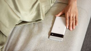 A Pixel 6 Pro in Cloudy White, beside someone on a seat