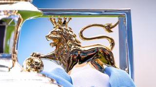  Detail of the lion on the Premier League trophy seen with blue and white ribbons on it ahead of the Premier League 2024/25