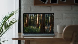 Edited image of a MacBook Pro with Sequoia background on screen