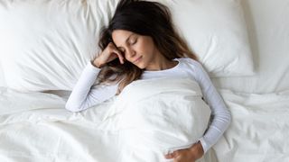 a photo of a woman asleep in bed