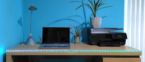 Twinkly Line smart lights on edge of desk, lit in green and blue gradient