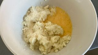 Potatoes for air fryer croquettes being mixed with flavorings and egg