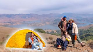 A woman sitting outside a tent next to a group of friends on a mountain