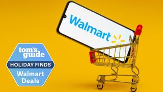 Mini shopping cart carrying a smartphone showing the Walmart logo