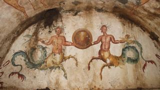 We see two ichthyocentaurs, which are part man, part horse and part fish, next to two cherubs on a half-circle wall.