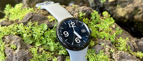 The Google Pixel Watch 3 sitting on a rock with the Pilot Bold watch face