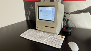 MacintoshPi sitting on a desk, with keyboard, mouse and joystick