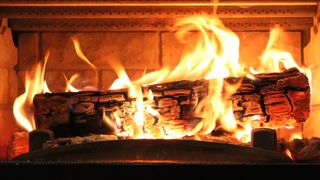 a yule log burning in the fireplace