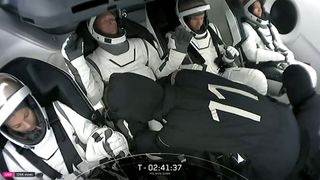 SpaceX's private Polaris Dawn astronauts inside Dragon and in the White Room access arm.