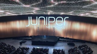 Antonio Neri on stage at HPE Discover 2024 keynote standing in front of a Juniper Networks logo