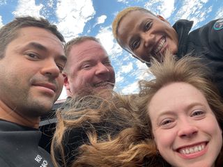 The Inspiration4 crew poses for a selfie in the cupola of their SpaceX Crew Dragon spacecraft.