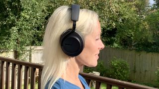 Shure Aonic 50 Gen 2 worn by TechRada'r's Becky Scarrott, in profile, in a garden