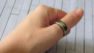 Woman's hand wearing Oura smart ring