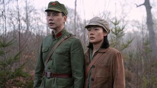 A Chinese soldier and Ye Wenjie stand in a field in Netflix's 3 Body Problem TV series