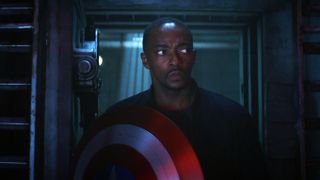 Sam Wilson walks through a dark corridor with Cap's shield in Captain America: Brave New World