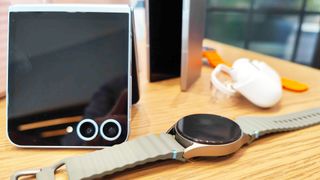 Samsung Galaxy Watch 7 next to Galaxy Flip 6 and Galaxy Buds Pro 3