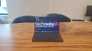 black gaming laptop on wooden table