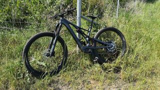 best electric bike Levo SL Expert Carbon eMTB next to a fence