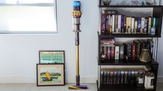 Dyson V15s Detect Submarine Complete standing next to a bookshelf