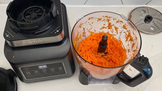 The Ninja 3-in-1 Food Processor with Auto-IQ BN800UK having been used to grate carrot in the food processor bowl