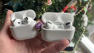 AirPods 4 and AirPods Pro 2, held together to show the differences