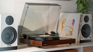 The Fluance RT81+ turntable pictured next to two speakers