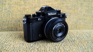 Nikon Z f camera on a vintage-style yellow chair