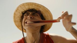 Iñaki Godoy as Monkey D. Luffy stretching his cheek during season one of the Netflix series One Piece.