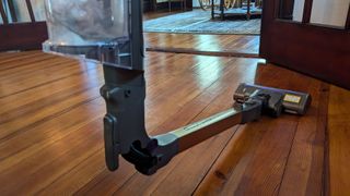 Wand on Shark PowerDetect Cordless vacuum cleaner bending forwards to reach under furniture