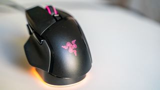 Razer Basilisk V3 Pro with Mouse Dock Pro on a white table