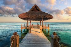 Palapa and wooden pier on the Carribean Sea, Dominican Republic.