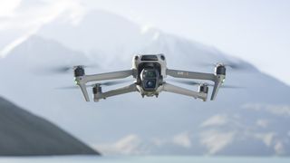 DJI Air 3S in flight with snow capped mountain backdrop