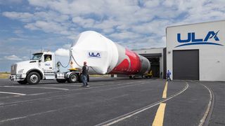 truck beside ula facility with rocket on board